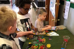 Children using colorful construction pieces at a table